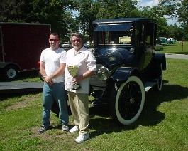 Sean Brayton (left) and Dick Shappy posing with the "Best of Show" trophy which was awarded to the 1915 Cadillac type 51 landaulet. (June 2004)